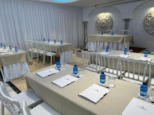 a room with tables and chairs with bottles of water on them at Hotel Villa Flamenca in Nerja