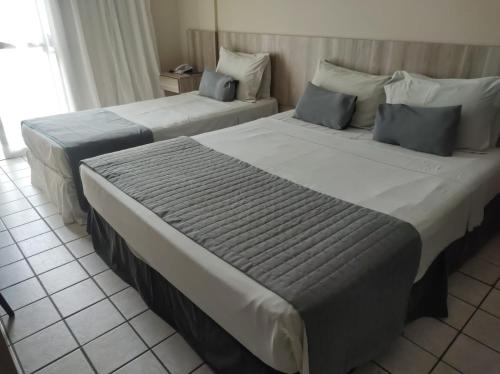 Кровать или кровати в номере Hotel Costa do Atlantico