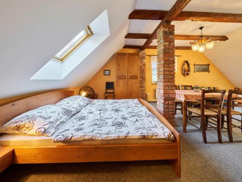 a bedroom with a bed and a dining room at Studio Chlívce u Hronova-2 by Interhome in Chlívce