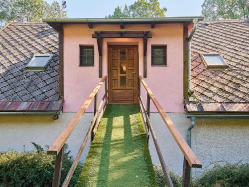 a house with a wooden door and a walkway at Studio Chlívce u Hronova-2 by Interhome in Chlívce