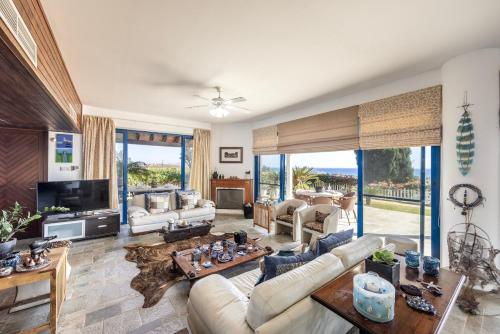 a living room with a couch and a tv at Ayia Napa Sycamore SeaView in Ayia Napa