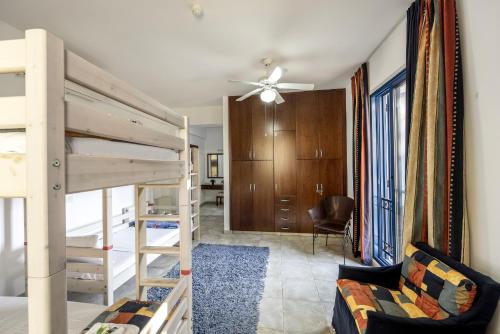 a bedroom with two bunk beds and a living room at Ayia Napa Sycamore SeaView in Ayia Napa