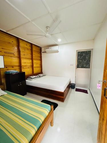 a small bedroom with a bed at Bashi eco beach cabana in Trincomalee