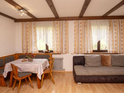 een woonkamer met een tafel en een bank bij Apartment Tirol by Interhome in Wagrain