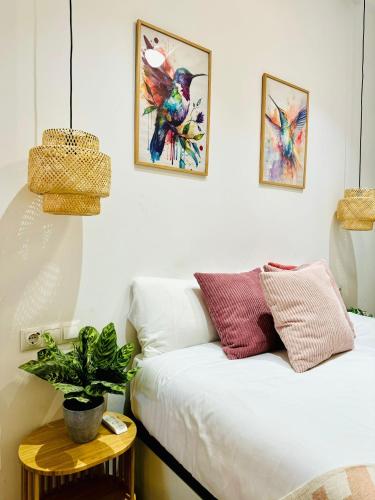 a living room with a white couch and a potted plant at Dorado Cabanyal - Luxury Beachside Charm in Valencia