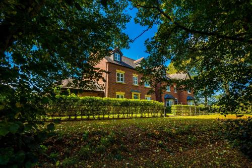 a large brick house with a fence in front of it at Grange House in Chester