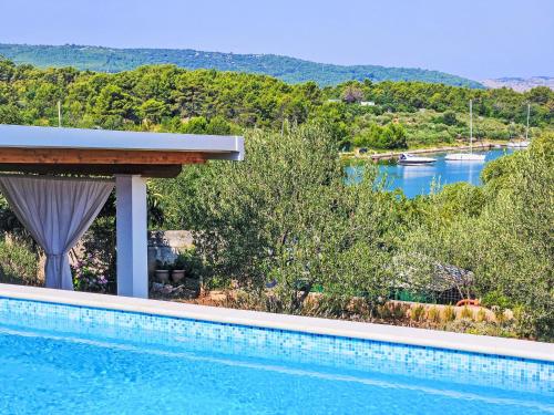 a swimming pool with a view of a river at Holiday Home Katenas by Interhome in Šibenik