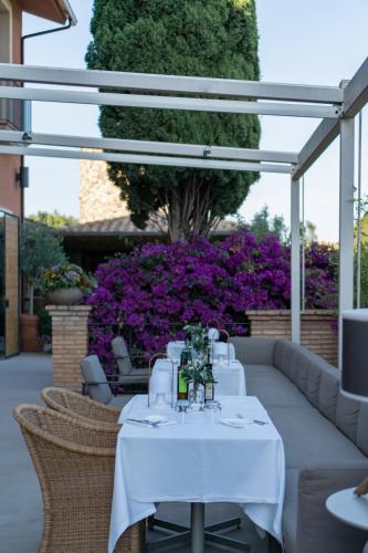 a white table with chairs and flowers on a patio at Hotel Peralada Wine Spa & Golf in Peralada