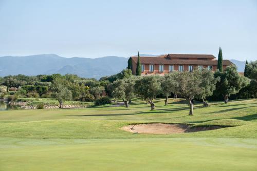 a view of a golf course with a building at Hotel Peralada Wine Spa & Golf in Peralada