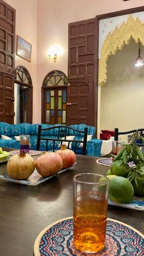 a table with two plates of food and a glass at Riad Dar Al Manzah in Rabat