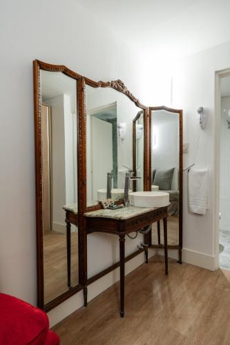 a bathroom with a sink and a mirror at Vain Boutique Hotel in Buenos Aires