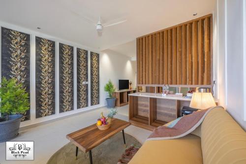 a living room with a couch and a table at The BlackPearl Hillcrest in Kasauli