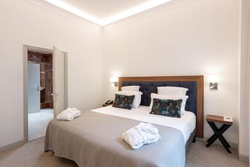 a bedroom with a large bed with towels on it at Westminster Hotel & Spa Nice in Nice