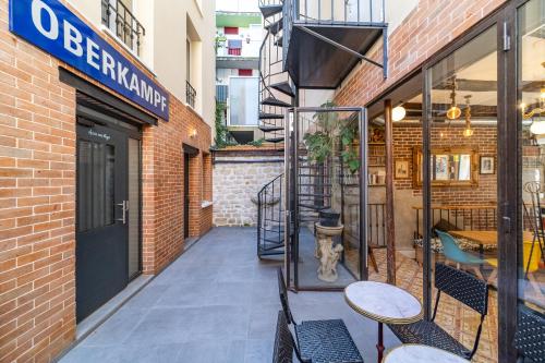 a patio with tables and chairs in front of a building at FRATERNiTY-HOTEL in Paris