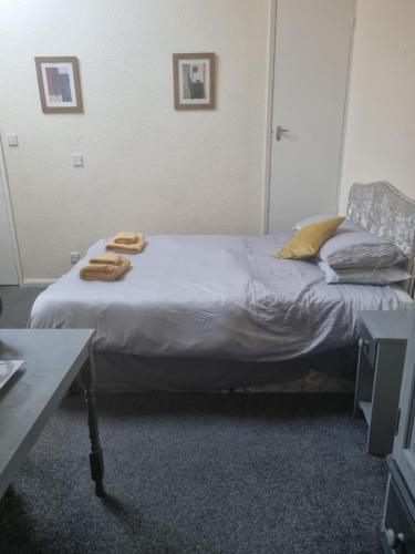 a bed in a room with two towels on it at The Red Lyon Slinfold in Slinfold