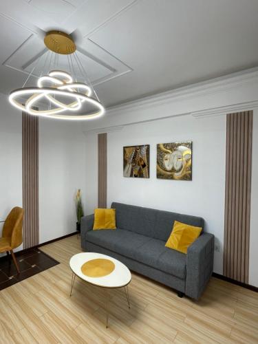 a living room with a couch and a table at MilitariResidence Luxury 54 in Roşu