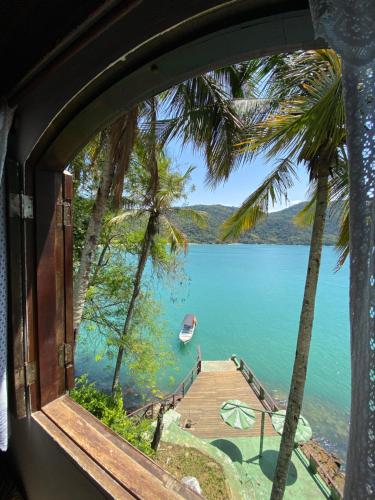 a view of a lake from a window at Pousada Ponta da Ilha, Ilha Grande, Angra dos Reis in Angra dos Reis