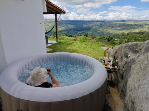a woman in a jacuzzi tub with a view at Villa Namaste - Cabaña Excélsior in Curití