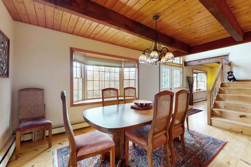 a dining room with a wooden table and chairs at Green Mountain Sunrise in Dover