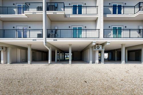 an apartment building with balconies and a beach at Port Paradise in Highland View