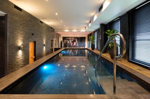 a swimming pool in a house at Van der Valk Hotel Hoorn in Hoorn