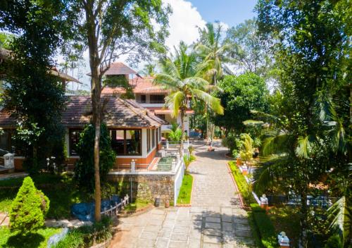 an aerial view of a house with a garden at Ushasree Wayanad Pool Resort by VOYE HOMES in Ambalavayal