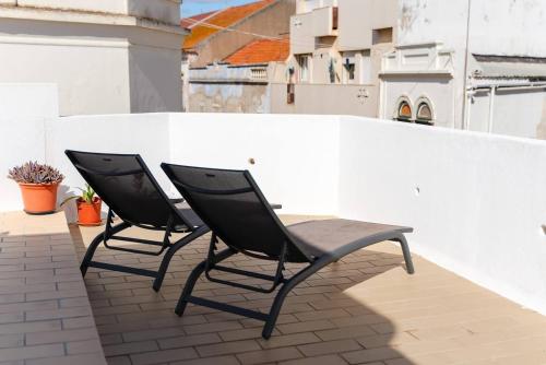 two chairs sitting on top of a balcony at Stylish apartment old town in Portimão