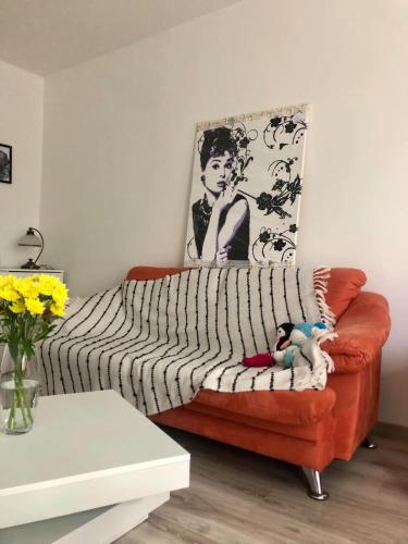 a living room with a couch with a blanket on it at Byt v centre mesta in Svidník