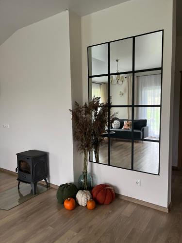 a living room with a mirror and pumpkins on the floor at Vila Trakai in Trakai