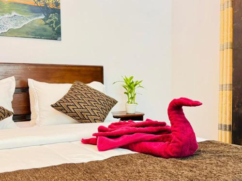 a red towel is laying on a bed at Rock Grand View in Ella