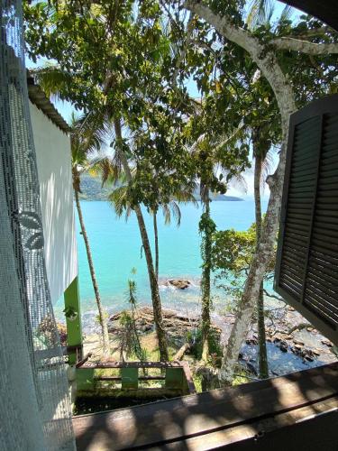 a view of the ocean from a window of a beach at Pousada Ponta da Ilha, Ilha Grande, Angra dos Reis in Angra dos Reis