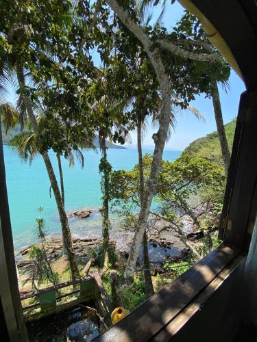 a view of the ocean from a window at Pousada Ponta da Ilha, Ilha Grande, Angra dos Reis in Angra dos Reis