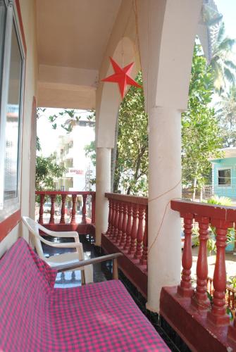 a balcony of a house with a star on the wall at Joe And Marietta's Guesthouse in Calangute