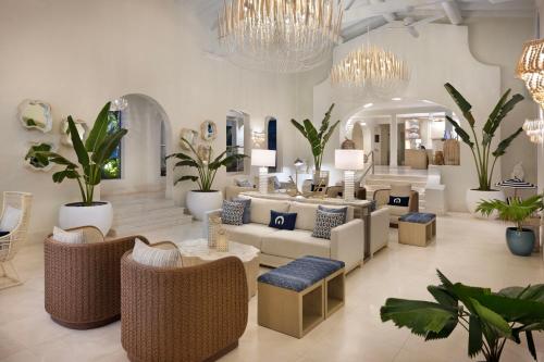 a lobby with a lot of furniture and plants at Windjammer Landing Resort and Residences in Gros Islet