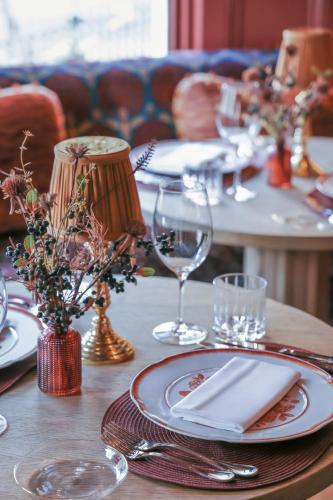 a table with plates and wine glasses on it at Meliá London Kensington Member of Meliá Collection in London
