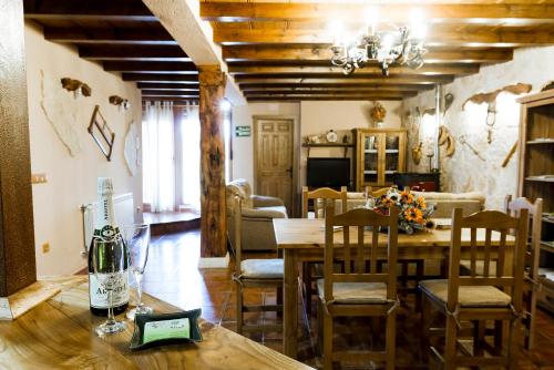 a dining room and living room with a table and chairs at La cañada real in Sigueruelo