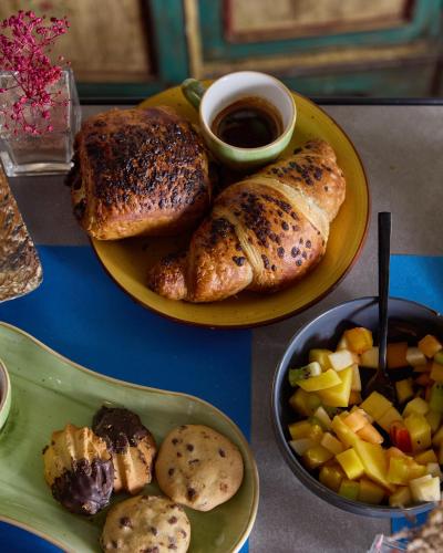 a table with two plates of food with bread and fruit at Apollo Boutique Hotel in Rome