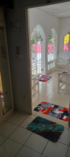 a living room with chairs and a rug on the floor at Holiday rooms in St Thomas Jamaica in Clifton