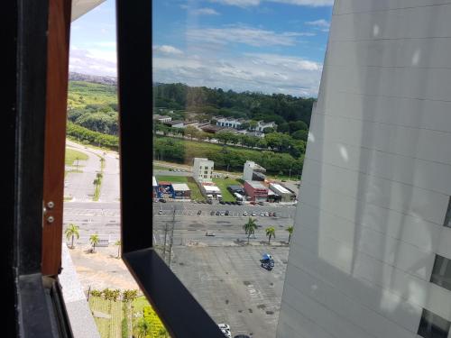 a view of a parking lot from a window at Flat Novo1 - Cama Queen, Ar, Estac e Internet in Barueri