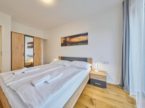 a bedroom with a large bed with white sheets at Apartment Trendy Mountain Terrace Retreat by Interhome in Svoboda nad Úpou