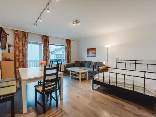 a bedroom with a bed and a living room at Apartment Landhaus St- Georg-2 by Interhome in Bad Gastein