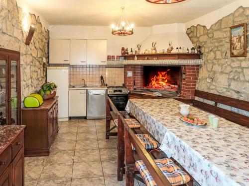 a kitchen with a fireplace and a stone wall at Holiday Home Villa Desanka by Interhome in Kršan