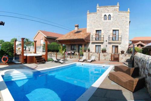 a large swimming pool in front of a house at Posada la Leyenda in Santillana del Mar