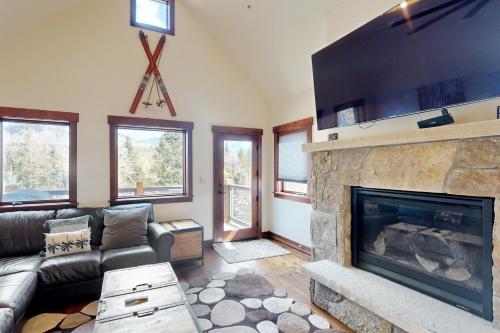 a living room with a fireplace and a couch at Blue River Condo Unit 203 in Silverthorne
