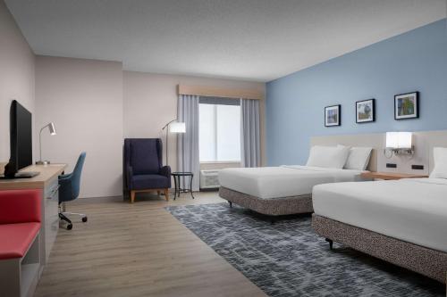 a hotel room with two beds and a television at Hilton Garden Inn Wilkes-Barre in Wilkes-Barre