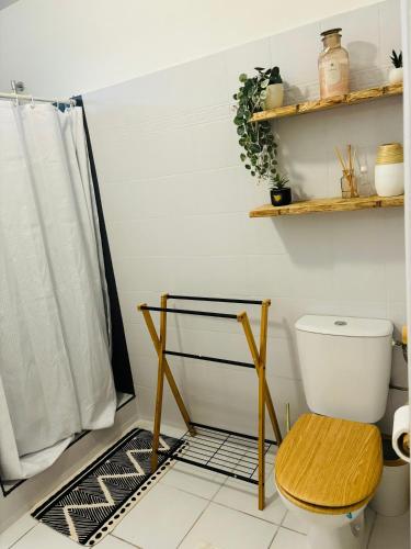 a bathroom with a toilet and a shelf at La Canopé - T2 calme et central avec son jacuzzi in Rémire-Camp