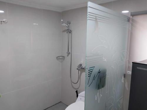 a bathroom with a shower and a toilet at Thula Thula Bali Villas in Kerobokan
