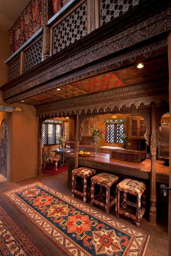 a room with a table and some chairs and a rug at The Inn of Five Graces in Santa Fe