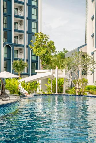 a swimming pool in the middle of a building at Title Halo Memories Naiyang Pool Gym Sauna in Nai Yang Beach