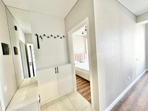 a white room with a closet and a bedroom at Уютные апартаменты в новострое на Ботанике in Chişinău